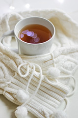 Gentle composition. Cup of tea on a warm cozy background.