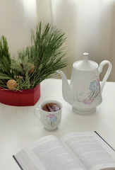 Delicate kettle and mug on a light background on the table