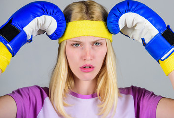 Girl boxing gloves tired to fight. Strong woman suffer pain. Girl painful face embrace head with...