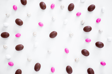 Easter concept - close up of eggs and sweets over white