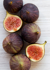 Fresh figs on white wooden table, overhead view. From above, flat lay. Close-up.