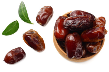 date fruits with green leaves isolated on white background. top view