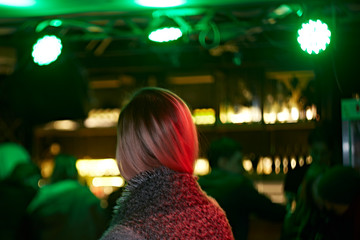 Back view of a blonde girl in a bar