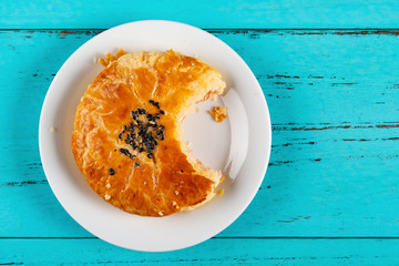 top view sesame seed cakes with a bite on blue background