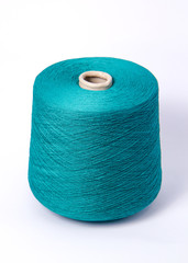 Blue bobbin of yarn on a white background.Textile reel on isolated white background.