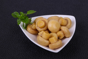 Pickled champignon heap in the bowl