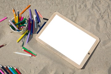 Back to school concept end of holidays white blank empty billboard on sand beach with pencil