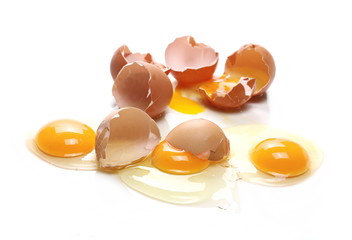 Broken eggs, eggshells with yolk isolated on white background
