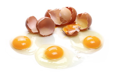 Broken eggs, eggshells with yolk isolated on white background