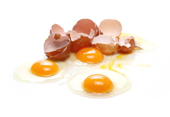 Broken eggs, eggshells with yolk isolated on white background