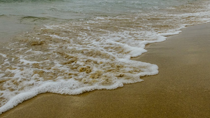 waves and sea foam run ashore