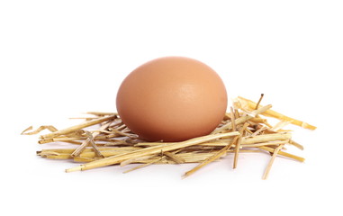 Eggs in straw nest isolated on white background