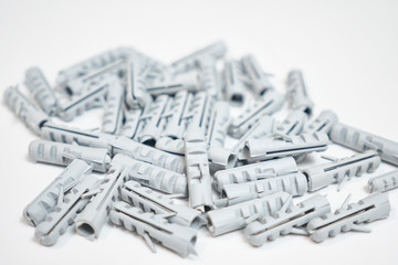 Plastic dowel pin or wall plugs on white background, selective focus