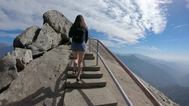 A girl climbing the Moro Rock in Sequoia National Park, California, USA