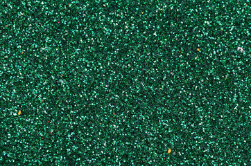 Colorful defocused emerald green background with glittering and sparkling spots