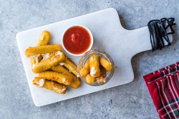 Breaded Fried Mozzarella Cheese Sticks with Ketchup Dipping Sauce.
