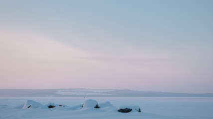 winter mountain landscape with frozen lake and blue sky