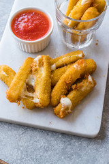 Breaded Fried Mozzarella Cheese Sticks with Ketchup Dipping Sauce.