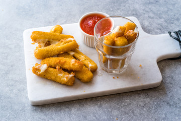 Breaded Fried Mozzarella Cheese Sticks with Ketchup Dipping Sauce.