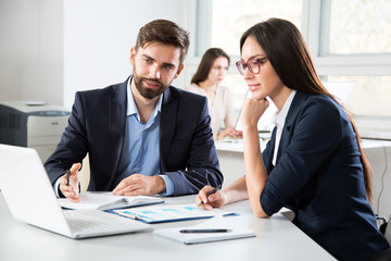 Businesspeople discuss a new project