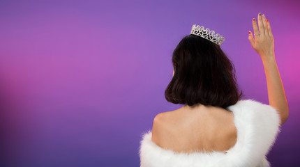 Back of Miss Pageant Beauty Contest in white fur Evening Ball Gown dress sparkle light Diamond Crown, Asian Woman fashion make up black hair style, studio lighting gradient shade purple background
