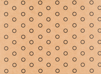 Brown craft paper with a black circle pattern