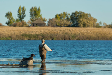A Duck hunter and his dog in North Dakota