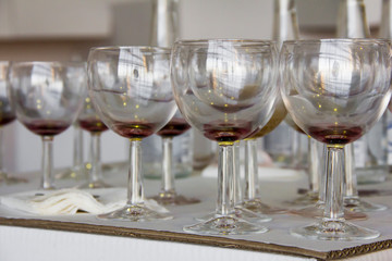 Wine glasses and bottles on the table after the exhibition opening and presentation.