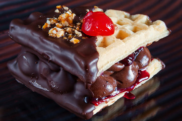 Belgian waffle with chocolate and cherry.