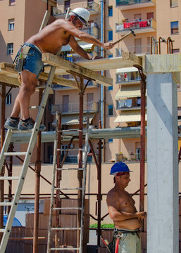 concrete work: workers carpenters preparing construction formwork for concreting at building area