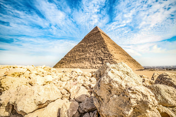 .View of the incredibly majestic pyramid of the cheops on a sunny day in the wilderness with the...