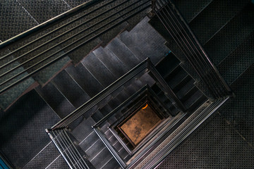 Square steel stairwell view from the top. - Powered by Adobe