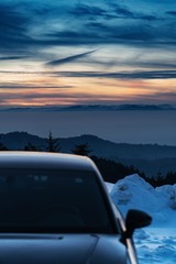 Fototapeta na wymiar Car on top of mountain on sunset