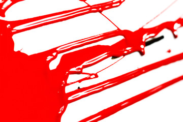Red paint drips on a white background. Paint flows