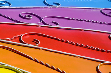 Metal texture of a piece of colored wall with a forged pattern