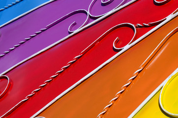 Metal texture of a piece of colored wall with a forged pattern