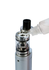 Filling of atomizer tank with e-liquid on white background. E-cigarette.