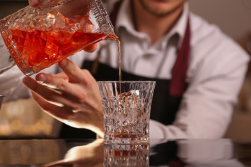 Barmen making negroni alcohol cocktail
