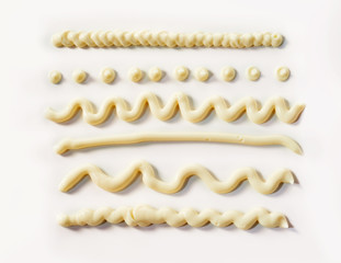 Decorative wavy lines and dots of mayonnaise