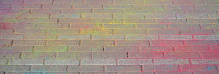 Multi colored paving slabs, powder coated with dry colors at the Holi festival