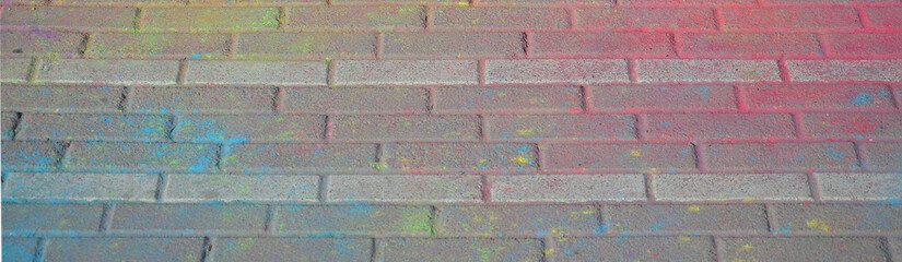 Multi colored paving slabs, powder coated with dry colors at the Holi festival