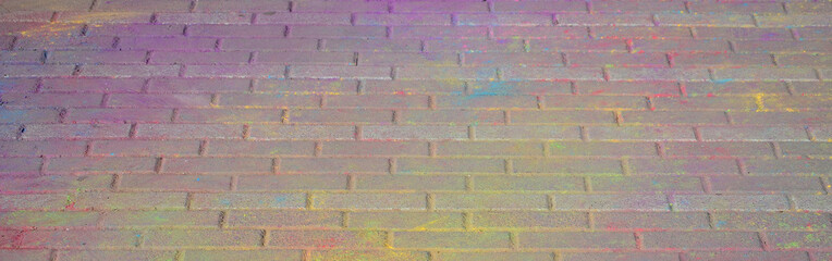 Multi colored paving slabs, powder coated with dry colors at the Holi festival