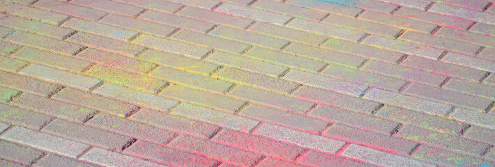 Multi colored paving slabs, powder coated with dry colors at the Holi festival
