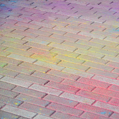 Multi colored paving slabs, powder coated with dry colors at the Holi festival