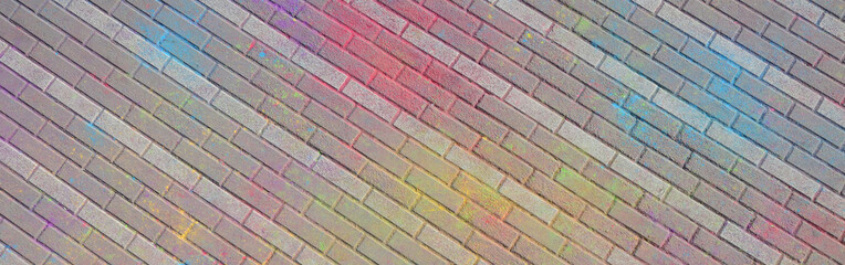 Multi colored paving slabs, powder coated with dry colors at the Holi festival