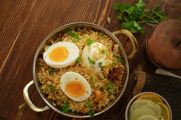 Homemade Spicy Dindigul Chettinadu Biryani or Pilaf on wooden background