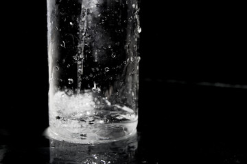 Splash of water on black, Stylish water splash. Isolated on black background, bubbles in the glass,