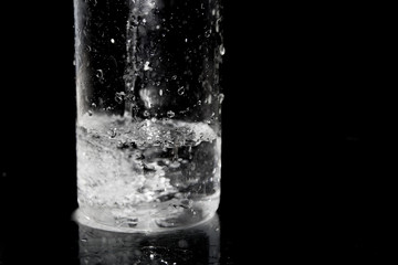 Splash of water on black, Stylish water splash. Isolated on black background, bubbles in the glass,