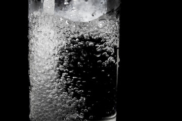 Splash of water on black, Stylish water splash. Isolated on black background, bubbles in the glass,