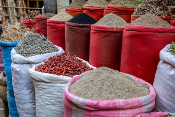  great variety of bright herbs and spices on the counter of the Arab market